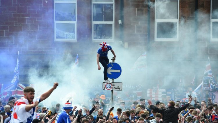 ‘Endangers lives’: Terrifying scenes as Rangers fans clash with police in WILD title celebrations